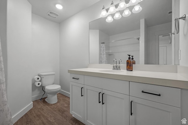 full bath featuring toilet, wood finished floors, baseboards, vanity, and curtained shower