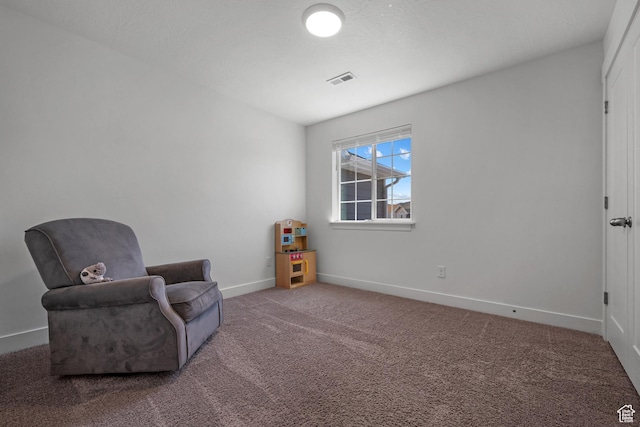 sitting room featuring carpet and baseboards