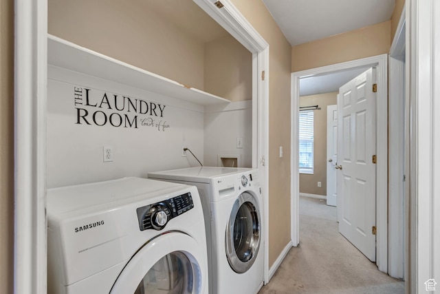 laundry room featuring independent washer and dryer, light carpet, and baseboards