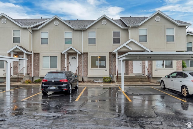 multi unit property with covered and uncovered parking and stucco siding