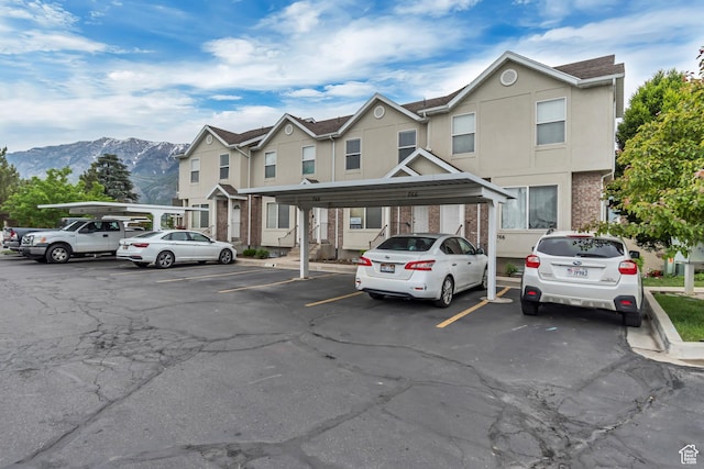 768 E 1740 S Unit 768, Orem, UT 84097 - view of property with covered and uncovered parking, a mountain view, and stucco siding