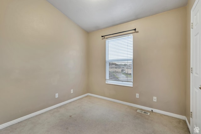 unfurnished room featuring carpet flooring and baseboards