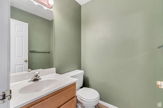bathroom featuring toilet and vanity