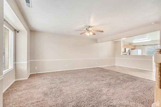 768 E 1740 S Unit 768, Orem, UT 84097 - spare room with a ceiling fan, light colored carpet, baseboards, and plenty of natural light