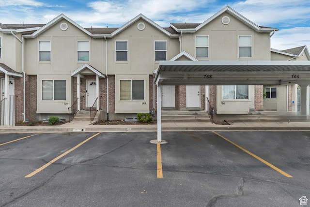 768 E 1740 S Unit 768, Orem, UT 84097 - view of property with entry steps, covered and uncovered parking, and stucco siding