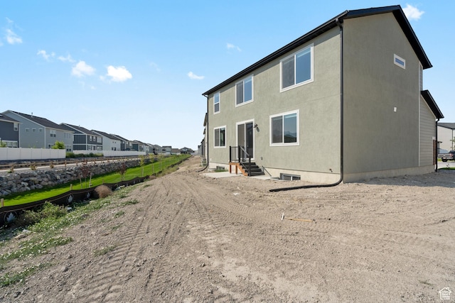 3523 N Browning St Unit 1233, Eagle Mountain, UT 84005 - back of house with a residential view, entry steps, and stucco siding