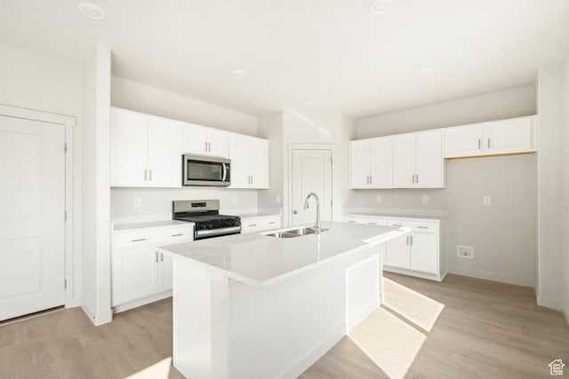 3523 N Browning St Unit 1233, Eagle Mountain, UT 84005 - kitchen with stainless steel microwave, gas range, and white cabinetry