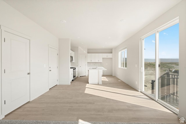 3523 N Browning St Unit 1233, Eagle Mountain, UT 84005 - unfurnished living room featuring a sink and light wood-style floors