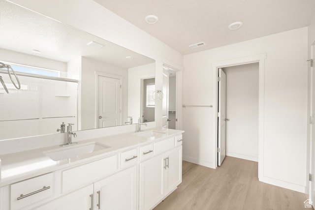 3523 N Browning St Unit 1233, Eagle Mountain, UT 84005 - bathroom featuring wood finished floors, double vanity, and a shower with door