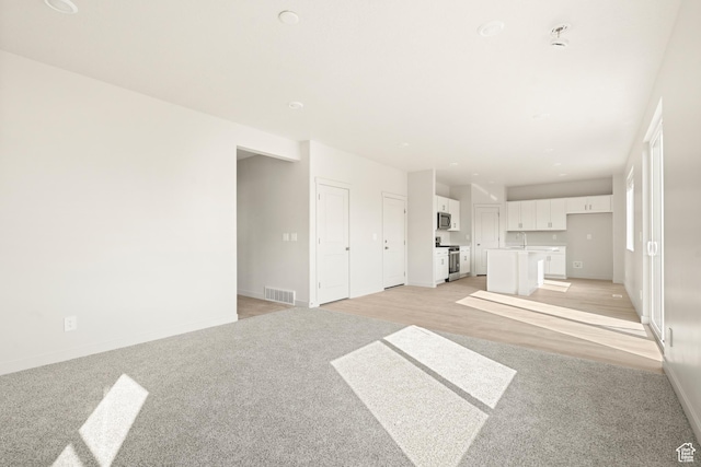 3523 N Browning St Unit 1233, Eagle Mountain, UT 84005 - unfurnished living room featuring light carpet and baseboards