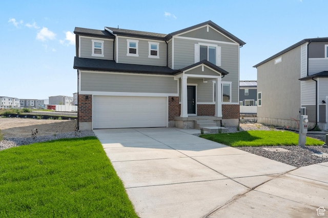 3523 N Browning St Unit 1233, Eagle Mountain, UT 84005 - craftsman-style home featuring brick siding, an attached garage, concrete driveway, and a front yard