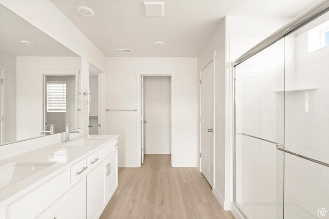 3523 N Browning St Unit 1233, Eagle Mountain, UT 84005 - bathroom with a stall shower, double vanity, and wood finished floors