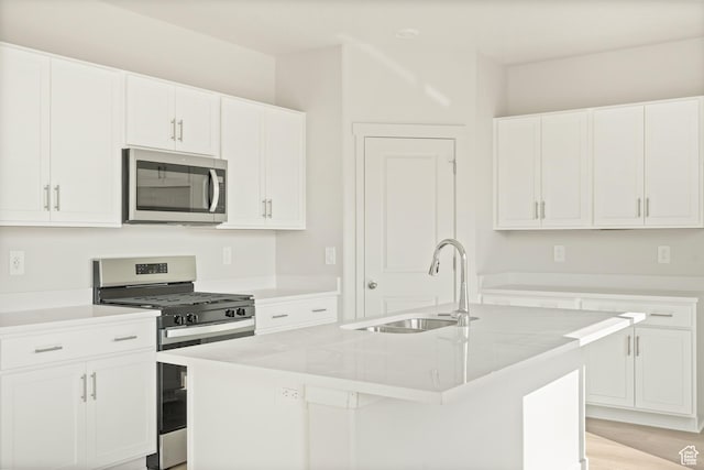 3523 N Browning St Unit 1233, Eagle Mountain, UT 84005 - kitchen featuring appliances with stainless steel finishes, a kitchen island with sink, and white cabinetry