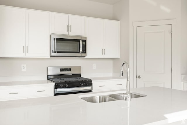 3523 N Browning St Unit 1233, Eagle Mountain, UT 84005 - kitchen with stainless steel microwave, gas range oven, light countertops, and white cabinets