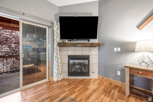 5501 Lillehammer Ln Unit 4306, Park City, UT 84098 - unfurnished living room with wood finished floors, a fireplace, and baseboards