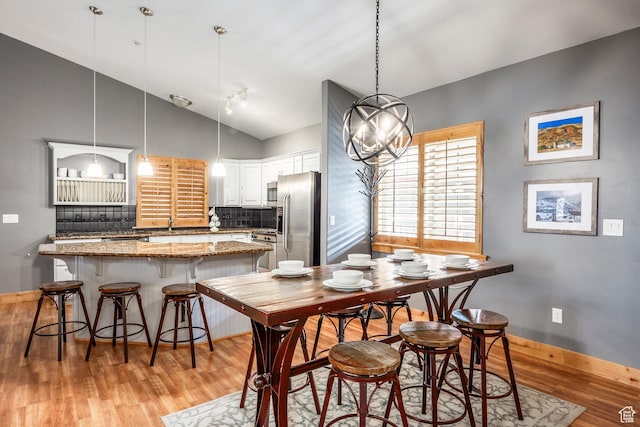 5501 Lillehammer Ln Unit 4306, Park City, UT 84098 - dining space featuring light wood finished floors, baseboards, and high vaulted ceiling