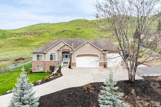 4248 N Sego Lily Rd, Morgan, UT 84050 - view of front of property featuring stucco siding, a garage, driveway, stone siding, and a mountain view