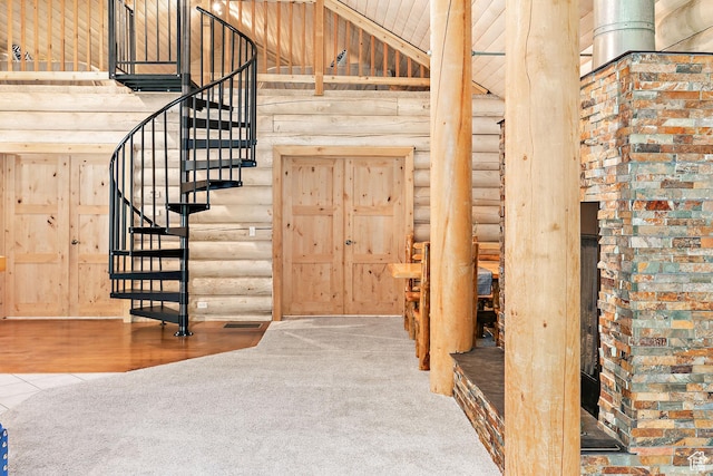stairs featuring high vaulted ceiling, carpet floors, and log walls