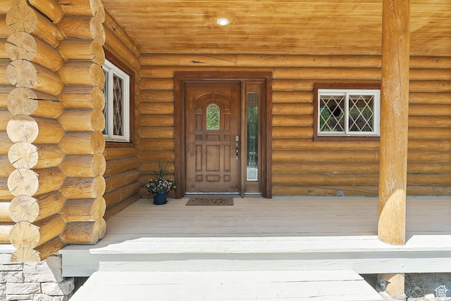 doorway to property with log exterior
