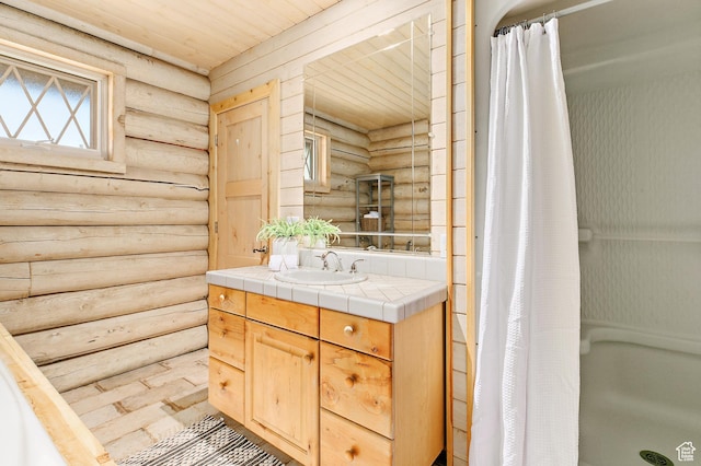 full bathroom with log walls, a shower stall, vanity, and wood ceiling
