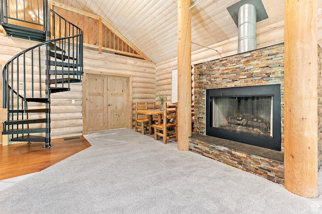 living area with carpet flooring, wooden ceiling, rustic walls, stairway, and a stone fireplace