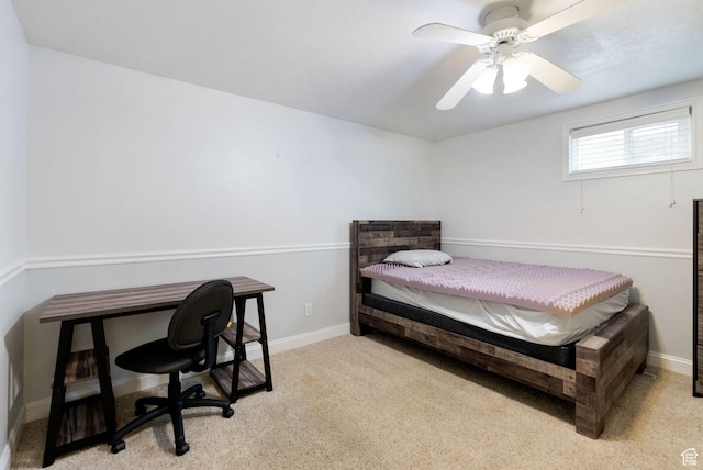 carpeted bedroom featuring a ceiling fan, baseboards, and an office area