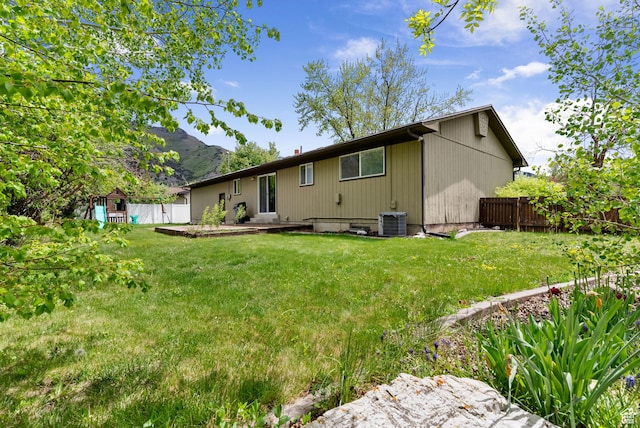 back of house featuring central air condition unit, a patio area, and a mountain view