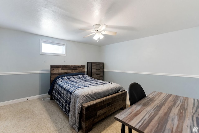 carpeted bedroom featuring baseboards and ceiling fan