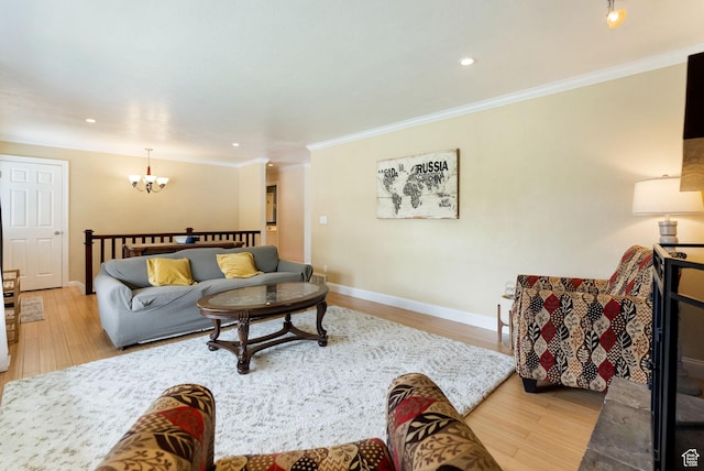 living area with a chandelier, wood finished floors, ornamental molding, baseboards, and recessed lighting