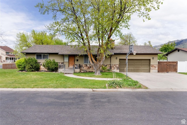 ranch-style house with stone siding, an attached garage, driveway, and roof with shingles