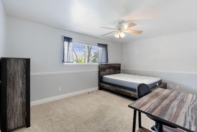 carpeted bedroom with baseboards and a ceiling fan