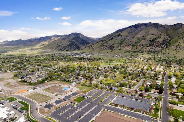 aerial view of property and surrounding area featuring mountains and nearby suburban area