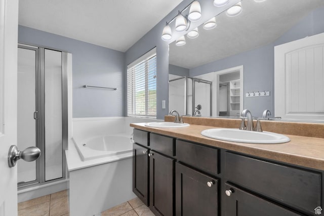 full bath with a stall shower, a bath, double vanity, and tile patterned flooring