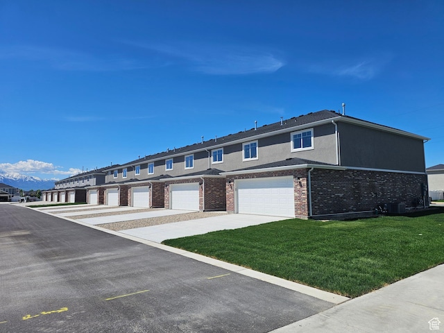 542 N 1400 W Lot 29, Springville, UT 84663 - multi unit property featuring a front yard, brick siding, central AC, stucco siding, and an attached garage