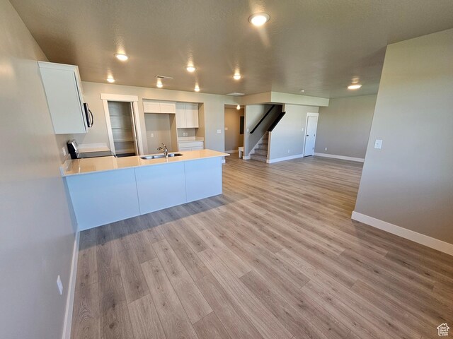 542 N 1400 W Lot 29, Springville, UT 84663 - kitchen featuring white cabinets, a peninsula, a sink, baseboards, and light countertops