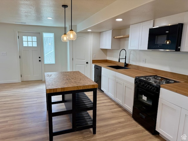 167 E Craner Peak Dr, Eagle Mountain, UT 84005 - kitchen with black appliances, white cabinetry, light wood-style floors, decorative light fixtures, and recessed lighting