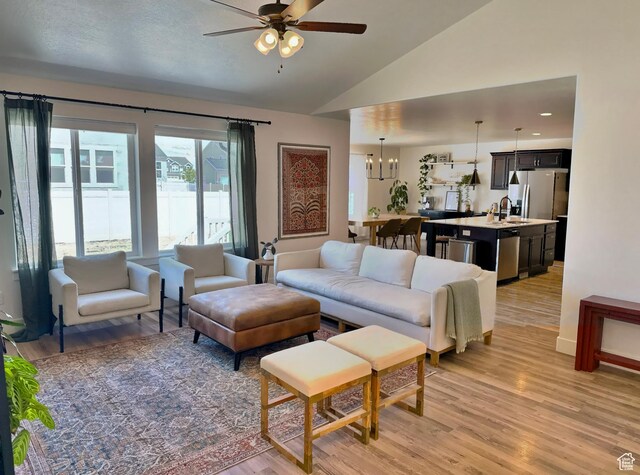 167 E Craner Peak Dr, Eagle Mountain, UT 84005 - living area with ceiling fan, light wood-style floors, vaulted ceiling, and a chandelier