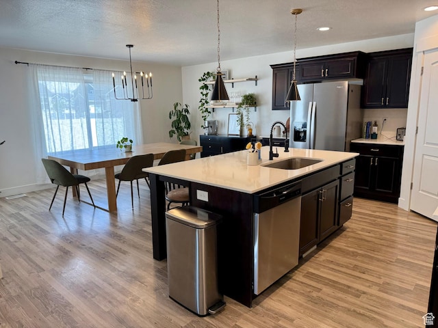 167 E Craner Peak Dr, Eagle Mountain, UT 84005 - kitchen with a sink, stainless steel appliances, a chandelier, light countertops, and light wood-style flooring