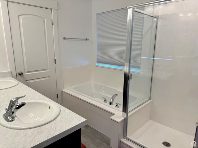 167 E Craner Peak Dr, Eagle Mountain, UT 84005 - full bath featuring a bath, a shower stall, double vanity, and wood finished floors