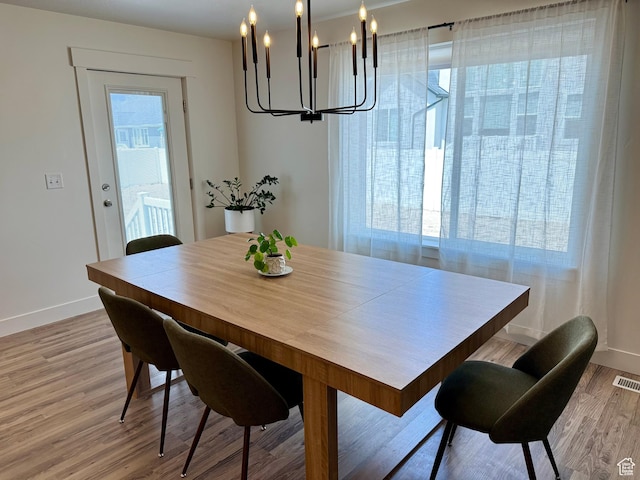 167 E Craner Peak Dr, Eagle Mountain, UT 84005 - dining space featuring a chandelier, baseboards, light wood finished floors, and plenty of natural light