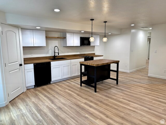 167 E Craner Peak Dr, Eagle Mountain, UT 84005 - kitchen with wooden counters, black appliances, a sink, light wood-type flooring, and recessed lighting