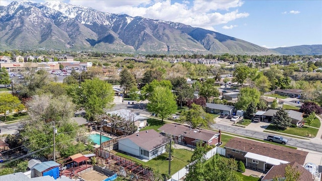 aerial view of residential area with a mountain backdrop and a pool