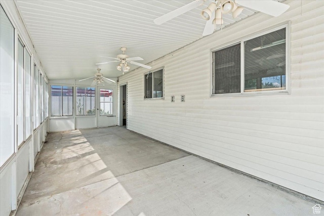 unfurnished sunroom featuring ceiling fan and vaulted ceiling