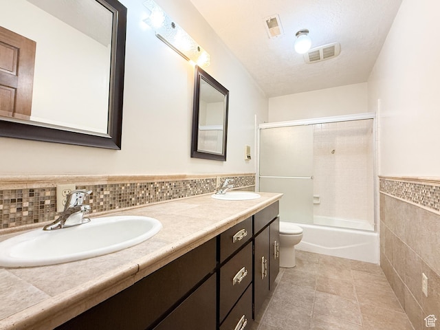 1145 E 1675 N, North Ogden, UT 84404 - bathroom featuring tile walls, toilet, double vanity, tile patterned floors, and wainscoting
