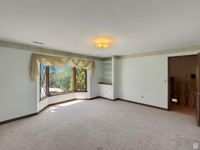 1145 E 1675 N, North Ogden, UT 84404 - empty room featuring a textured ceiling, light carpet, and baseboards
