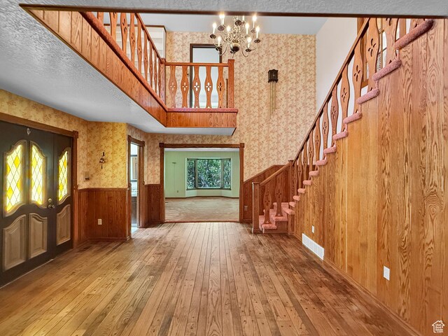 1145 E 1675 N, North Ogden, UT 84404 - entryway featuring stairway, hardwood / wood-style flooring, a wainscoted wall, wallpapered walls, and a chandelier