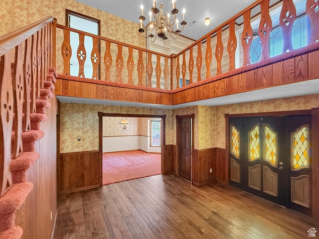 1145 E 1675 N, North Ogden, UT 84404 - foyer featuring wallpapered walls, wainscoting, hardwood / wood-style flooring, a chandelier, and a towering ceiling