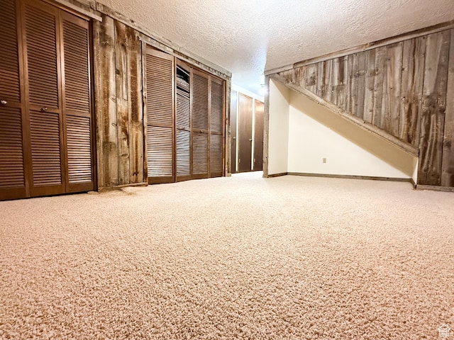 1145 E 1675 N, North Ogden, UT 84404 - basement with a textured ceiling, wooden walls, carpet flooring, and baseboards