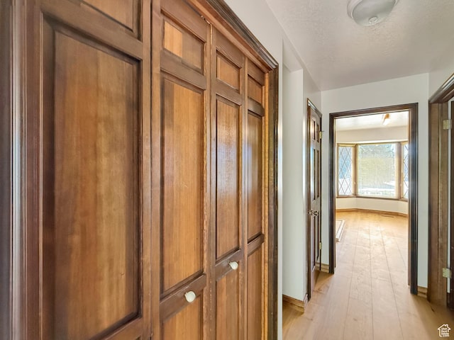 1145 E 1675 N, North Ogden, UT 84404 - hallway with light wood finished floors, baseboards, and a textured ceiling