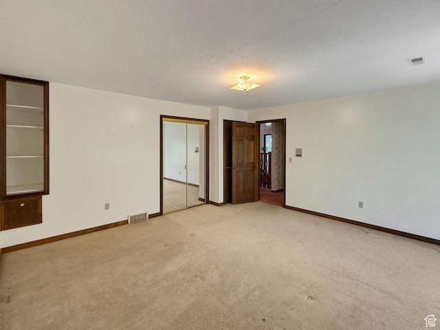 1145 E 1675 N, North Ogden, UT 84404 - spare room featuring light colored carpet, baseboards, and a textured ceiling